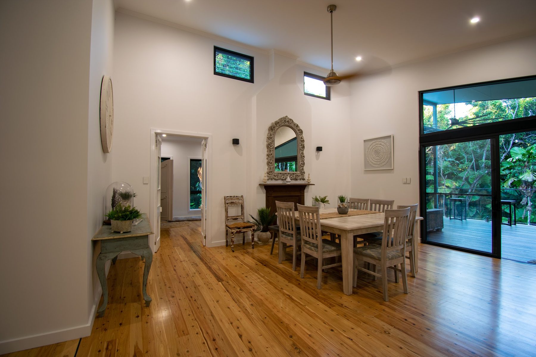 The dining room of the rainforest home, high raked ceiling with pendant and downlights
