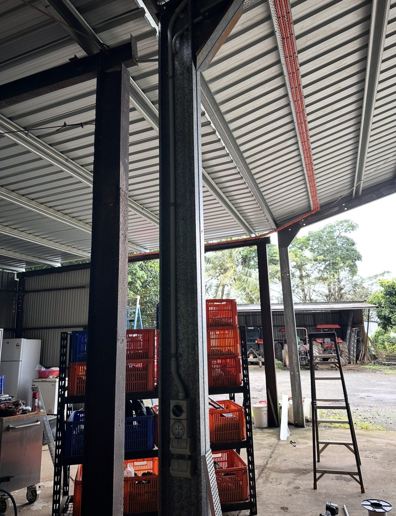 An isolator and weatherproof power point installed on the post of a working farm shed